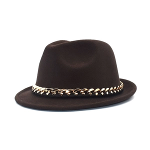 Detailed view of brown wool fedora hat featuring a chunky gold chain trim on white background