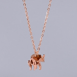 Detail of rose gold elephant pendant featuring unique geometric cutout design and link chain