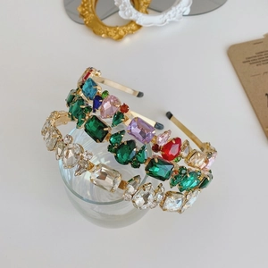 Close-up of Baroque headband with large colorful crystals on a gold metal frame