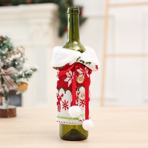 Close-up of knitted Christmas wine bottle cover with elk patterns and faux fur collar