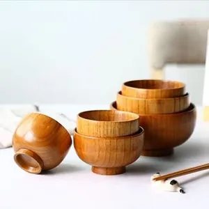 Macro detail of stacking Japanese style wooden nesting bowls with natural wood grain texture