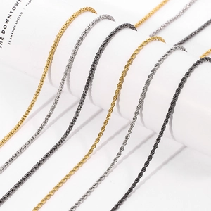 Detail of rope and popcorn chains in gold, silver and black finishes on white props