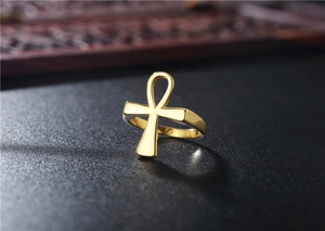 Close-up of golden Egyptian Ankh cross ring with a polished stainless steel finish
