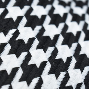 Gros plan sur la texture en coton pied-de-poule noir et blanc de la casquette marine rétro