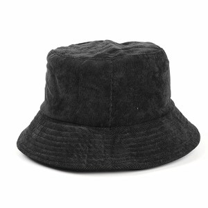 Close-up of black corduroy bucket hat texture showing vertical stripes and soft fabric