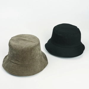 Close-up view of brown corduroy and black fabric bucket hats for autumn winter