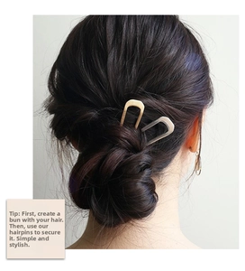 Detail of U-shaped metal hair pin set in gold and silver finish for bun hairstyles