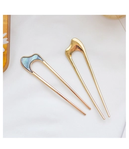 Detail view of U-shaped metal hair pins with minimalist shell inlay decoration