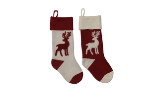 Detail of red and white knitted Christmas stockings featuring elk embroidery and hanging loops