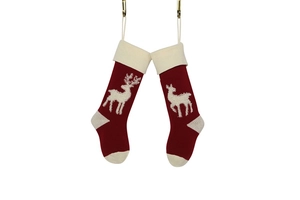 Close-up of knitted Christmas stockings with reindeer patterns in red and white