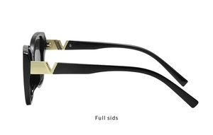 Detail view of stylish black square sunglasses featuring a golden V-shaped metal accent