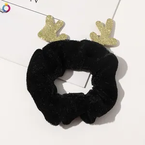 Detail of Christmas reindeer scrunchie with black velvet and golden glitter antlers