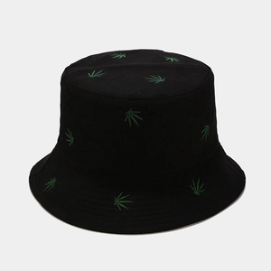 Close-up of green leaf embroidery on black cotton bucket hat with detailed stitching