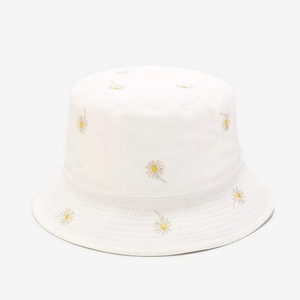 Detailed close-up of white daisy embroidery and reinforced stitching on cotton sun hat