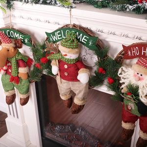 Three Nordic Christmas wreaths featuring Santa, Snowman, and Reindeer hanging on a white fireplace