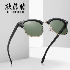 Detail view of vintage semi-rimless sunglasses with gold metal frame and dark green lenses