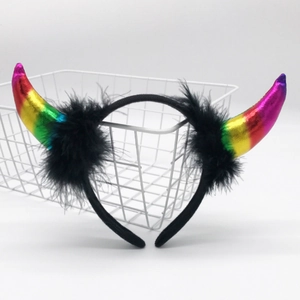 Detailed shot of metallic rainbow horns headband with soft black feather trim decor