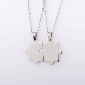Detail view of silver puzzle piece pendant necklaces with complementary interlocking design