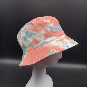 Close-up of tie-dye bucket hat with orange and blue paisley print on twill cotton