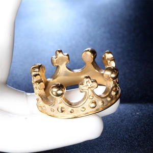 Detailed view of golden stainless steel crown ring with embossed cross and bead details