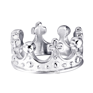 Macro detail of a silver stainless steel crown ring featuring a cross and polished finish