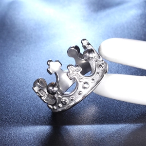 Detailed close-up of a silver titanium steel crown ring with intricate hollow engraving