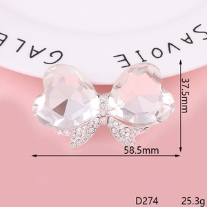 Bow brooch with transparent crystals and silver metal base, size 58.5mm x 37.5mm
