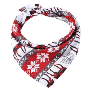 Detail of Christmas pet bandana with reindeer and snowflake patterns in red and white