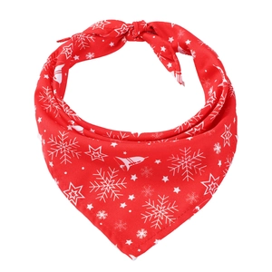Detail of red Christmas pet bandana with white snowflake patterns and fabric texture