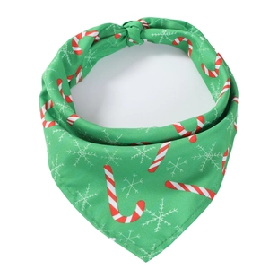 Detail of green Christmas pet bandana with candy cane and snowflake patterns