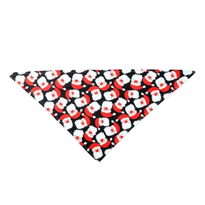 Detail of a black pet bandana featuring festive Santa Claus patterns and soft fabric texture