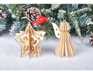 Detail of wooden 3D star and angel ornaments on snowy pine branches and red berries