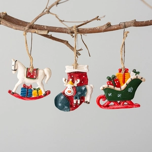 Vintage Christmas resin ornaments set with horse, stocking, and sleigh on rustic branch