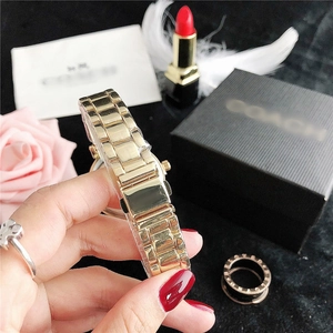 Detailed close-up of a premium gold stainless steel three-link watch band with folding clasp