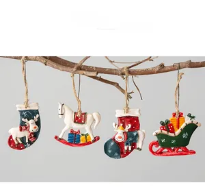 Detailed view of four vintage Christmas resin ornaments with rustic ropes on wood branches