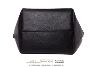 Detailed view of the black lychee pattern leather tote bag bottom with neat stitching