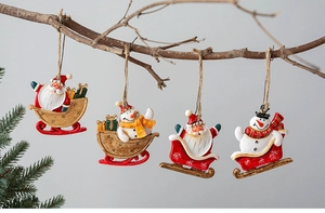 Detailed view of four resin Christmas tree ornaments with Santa and Snowman hanging on a branch