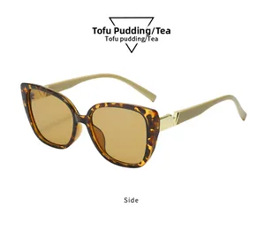 Detail view of square oversized sunglasses with tortoise frame and gold V metal accents