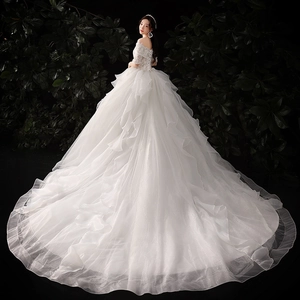 Elegant off-shoulder wedding dress with sequin lace bodice and long tiered ruffle train