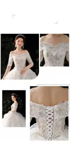 Close-up of elegant off-shoulder lace embroidery and corset lace-up back on a white wedding gown