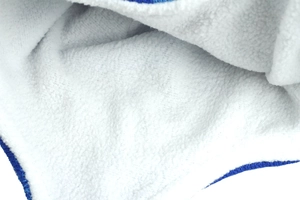 Close-up of thick white fleece lining and navy blue knitted edge for thermal warmth