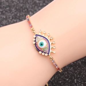 Golden Evil Eye chain bracelet with colorful zircons and blue enamel charm on wrist