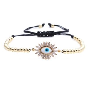 Macro shot of evil eye bracelet with baguette zircon stones and adjustable black cord