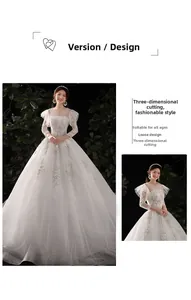 Détail de la broderie en dentelle et des poignets à volants sur la robe de mariée