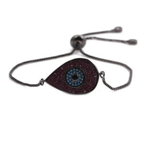 Macro detail of copper evil eye bracelet with colorful zircons and adjustable slider chain