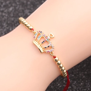 Goldenes Kronenarmband mit bunten Zirkonia und rotem Seil für Damen und Herren