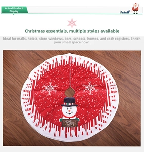 Detail of red Christmas tree skirt featuring a snowman and Warm Wishes sign