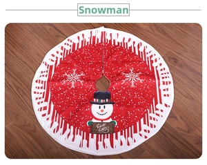 Detail of red Christmas tree skirt featuring a snowman with Warm Wishes sign