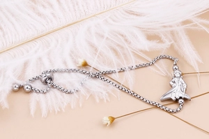 Detailed macro view of the silver Little Prince pendant on a box chain bracelet