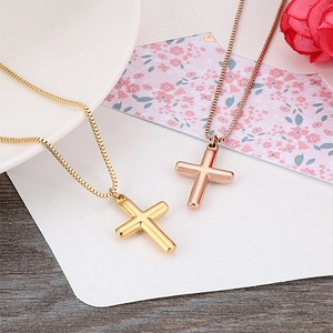 Minimalist gold and rose gold cross pendant necklaces on elegant decorative display